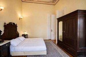 a bedroom with a large bed and a dresser at Loriet Hotel in Mytilene
