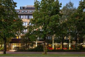 a building with trees in front of it at City Hotel MAX Munich West in Munich