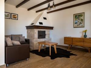 a living room with a couch and a fireplace at Villa Maslina in Novalja