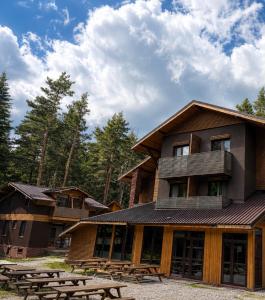 a building with picnic tables in front of it at RILA 6ATO Hotel & Restaurant in Panichishte