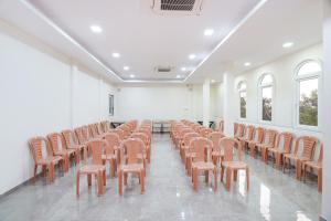 a room with a bunch of chairs in a room at FabHotel Nakshtra Resort in Tāsgaon
