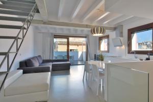 a kitchen and living room with a staircase in a house at Lonja Suites Apartments in Palma de Mallorca