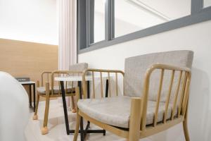 two chairs and a table in a room at Rium Hotel in Mokpo