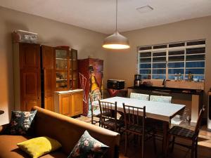 a living room with a couch and a table at Villa Dona Jaca - Casa da Mata - Casa 02 in Socorro