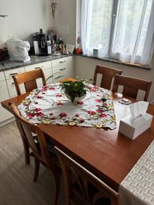 a table with a table cloth with flowers on it at Dachstudio in Kaiseraugst +7 photos