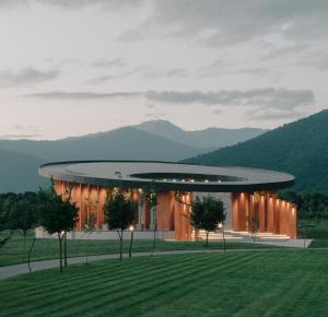 a rendering of a building with mountains in the background at Lopota Lake Resort & Spa in Napareuli