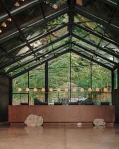 a room with a large glass wall with rocks in it at Lopota Lake Resort & Spa in Napareuli +171 photos