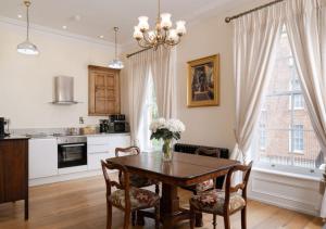 a kitchen and dining room with a table and chairs at Bishop's Gate Hotel in Derry Londonderry
