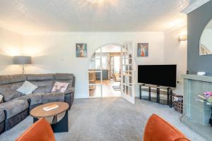a living room with a couch and a tv at 3 Bed in Skegness oc-b33460 in Orby