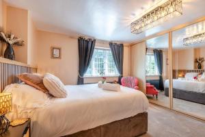 a bedroom with a large bed and a large mirror at 3 Bed in Skegness oc-b33460 in Orby