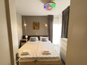 a small bedroom with a bed and a window at Yucca Park ApartHotel in Adeje +44 photos