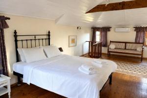 a bedroom with a large white bed and a couch at Loriet Hotel in Mytilene