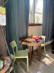 a dining room table with a green chair and a table at Glamping sin salir de la CDMX in Mexico City +37 photos
