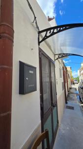 a window on a building with a television on it at Casa Alba in Bernalda
