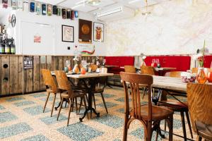 a restaurant with tables and chairs and a map on the wall at Vins de Dagne in Montlaur