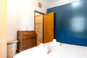a bedroom with a bed and a wooden cabinet at Arco Park View By Immobilux in Arco