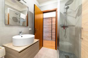 a bathroom with a sink and a shower at Arco Park View By Immobilux in Arco +21 photos