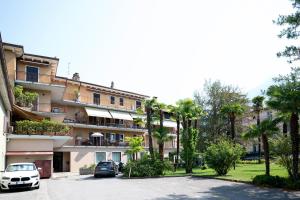 a building with cars parked in a parking lot at Arco Park View By Immobilux in Arco
