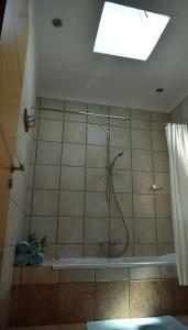a bathroom with a shower with a shower curtain at Olous Secret Hideaway - Sea View Studio Elounda in Elounda