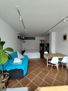 a living room with a couch and a table at Gigi Beachfront in Ferrel