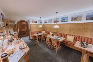 a restaurant with tables and chairs in a room at Sonnenhang Montafon in Sankt Gallenkirch