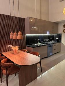 a kitchen with a wooden table with chairs and a counter at GUELIZ Seven Stays in Marrakesh
