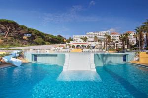 a swimming pool with a slide in a resort at Grand Muthu Oura View Beach Club in Albufeira