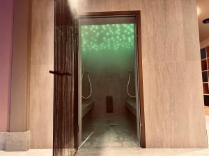 a bathroom with a shower with a glass door at Hotel Artos Interlaken in Interlaken