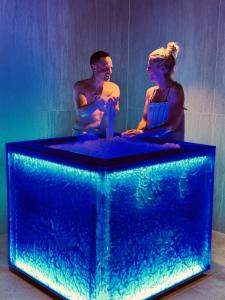 a man and a woman in a large aquarium at Hotel Artos Interlaken in Interlaken