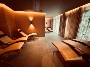 a waiting room with a row of chairs in a building at Hotel Artos Interlaken in Interlaken