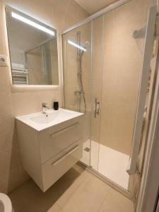 a bathroom with a white sink and a shower at Centre ville - Houilles A1 in Houilles
