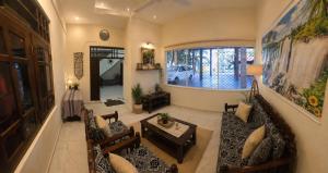 a living room with a couch and a table at Beach Guest House Addalaichenai in Addalachenai