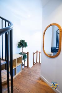 a mirror on a wall next to a staircase at Le Petit Noirda in Audresselles +18 photos