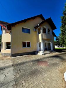 a large house with a driveway in front of it at Casa Elena in Râmnicu Vâlcea