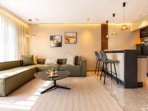 a living room with a couch and a table at The Magic Place - Ocean Walk and Pool Access in Anfa-Supérieur