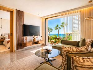 a living room with a couch and a table at The Magic Place - Ocean Walk and Pool Access in Anfa-Supérieur