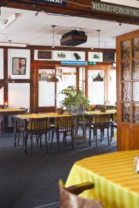 HCR De Tukker في Westdorpe: غرفة طعام مع طاولات وكراسي مع طاولة قماش صفراء