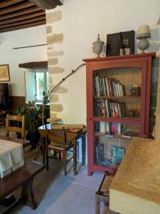 a living room with a book shelf filled with books at La Tuilerie Du Cinéaste in Courlon