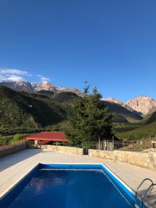 a swimming pool with mountains in the background at Hotel de la Cañada Valle de Uco in Tunuyán