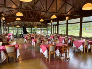 a dining room with pink tables and chairs at Hotel de la Cañada Valle de Uco in Tunuyán