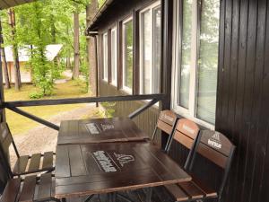 a porch with two chairs and a table and a window at Царів Хутір in Tsarivka