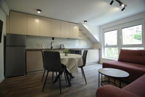 a kitchen and living room with a table and a couch at RiverSide Apartments in Veles