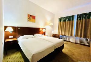 a bedroom with a large bed in a hotel room at Hotel Braník in Prague +50 photos