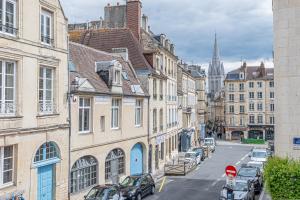 a street in a city with buildings and a church at Federer - Dans l'hypercentre de Caen in Caen