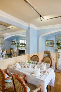 a dining room with a table and chairs and a mirror at The Atherstone Red Lion Hotel in Atherstone
