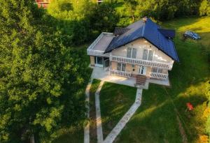 an overhead view of a house with a blue roof at Villa Riverside Haven in Hadžići