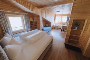 a bedroom with a large bed in a wooden room at Sonnenhang Montafon in Sankt Gallenkirch