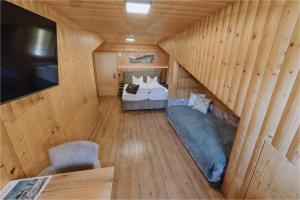 a bedroom with a bed in a wooden room at Sonnenhang Montafon in Sankt Gallenkirch