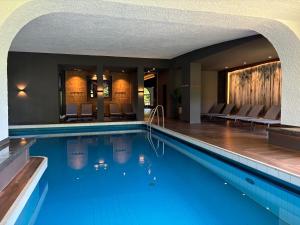 a swimming pool with blue water in a hotel at Parkhotel Luise Bad Herrenalb in Bad Herrenalb +28 photos