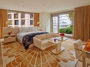a hotel room with a bed and a couch at Faena New York in New York +125 photos